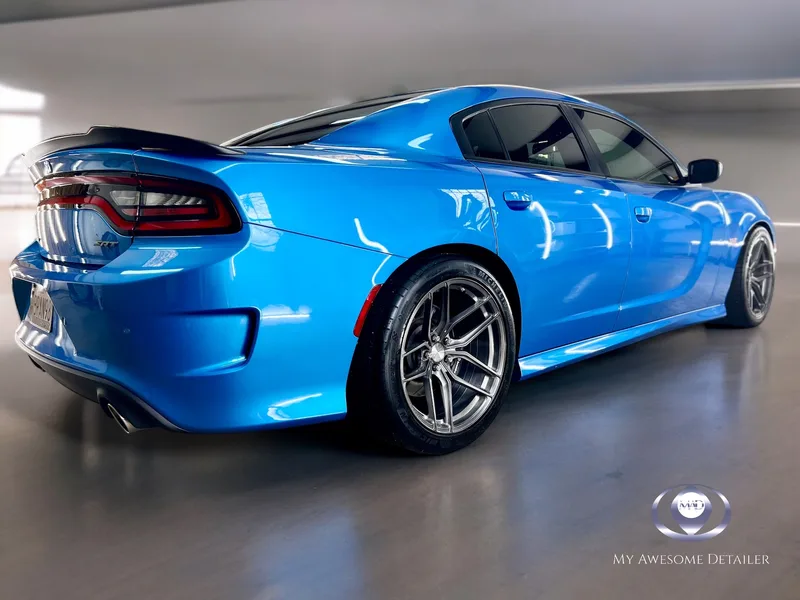 Blue Dodge Charger SRT rear quarter in shop